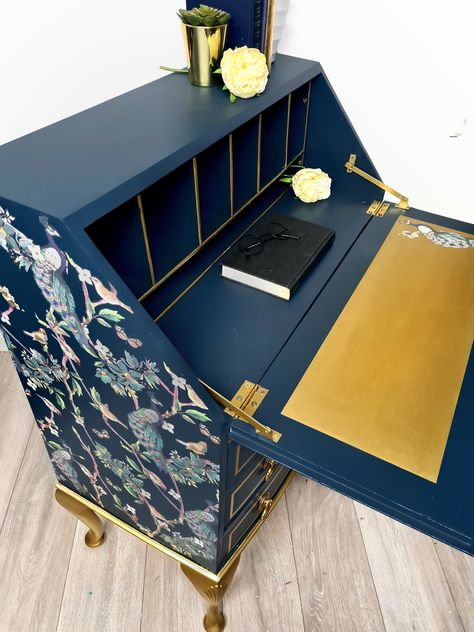 his beautiful peacock bureau desk has plenty of storage space with its 3 large drawers and additional cubby holes.Handpainted in buntys bewitched and navy tone mineral paint with a Gold pigment paint which has been use for the stunning queen anne style legs and used to highlight the cubby holes and back panel. Either side of the bureau we have used a re design prima furniture tranfer avain sanctuary and used a piece inside the pull down compartment.The pull down compartment door has been sanded Vintage Bureau Desk, Painted Writing Bureau, Bureau Desk Upcycle, Desk Upcycle Ideas, Bureau Upcycle, Painted Writing Desk, Drawers Makeover, G Plan Sideboard, Vintage Writing Desk