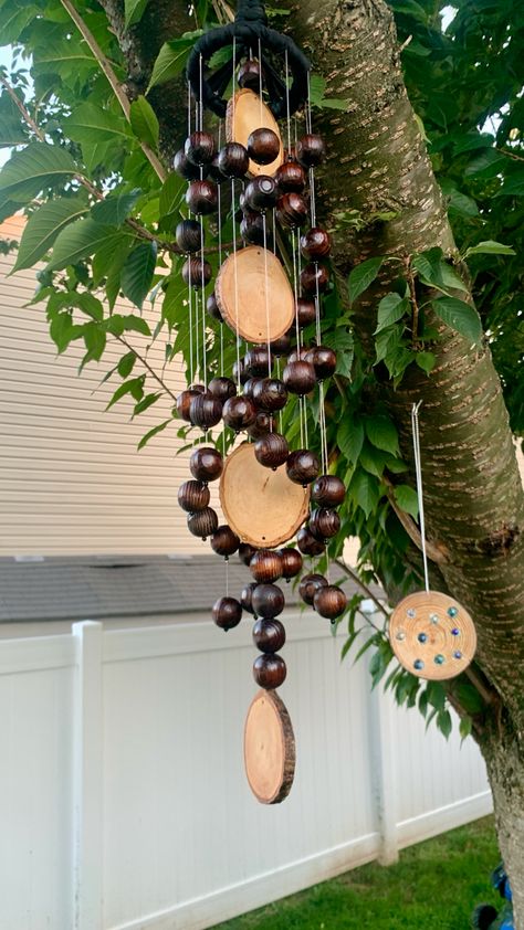 Made with wooden beads and real wood slices hung with fishing line Wood Wind Chimes Diy, Wood Chimes, Zen Garden Ideas, Garden Ideas On A Budget, Tiny Workshop, Windchimes Diy, Stone Paths, Birdhouse Ideas, Wooden Wind Chimes