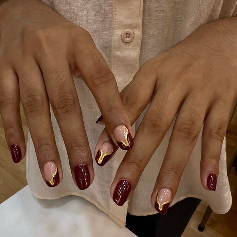 Nails as rich as fine wine, with a touch of gold. 🍷💛 To book your appointment: 🤳Call or WhatsApp at +98670 78427 OR 👩🏻‍💻Book Online 🏷️-red nails, burgundy nails, burgundy wine nails, burgundy and gold nails, nail art, nail extensions, nail goals #AtThePod #TheSugarPod #NaviMumbai #nailartclub #nailgoals #nailextensions #acrylicnails #burgundynails #burgundyandgoldnails #naildesigns #nailartinspo #nailsoftheday Cherry Red Nails With Gold Accents, Dark Red Gold Nails, Burgundy Gold Nail Designs, Nails Burgundy And Gold, Gold And Burgundy Nails, Burgundy Gold Nails, Wine And Gold Nails, Gold Burgundy Nails, Burgundy Nails With Gold