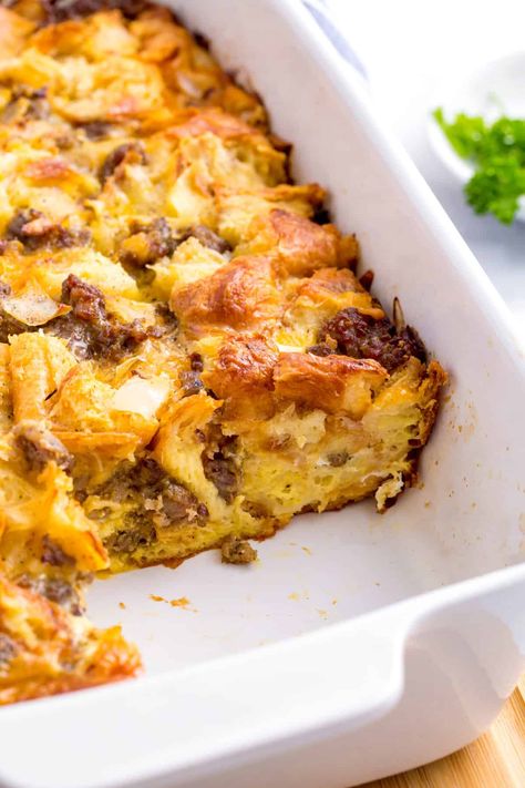 This easy sausage croissant breakfast casserole is the perfect make ahead meal. The flakey croissants, hearty sausages, and delicious cheese are a winning combination. Cheesy Sausage And Croissant Casserole, Croissants Breakfast Casserole, Sausage Crossaint Casserole, Breakfast Casserole With Croissants And Sausage, Sausage Egg Cheese Croissant Casserole, Sausage Croissant Breakfast Casserole, Croissant Roll Breakfast Casserole, Easy Breakfast Casserole With Croissants, Sausage Egg Croissant Casserole