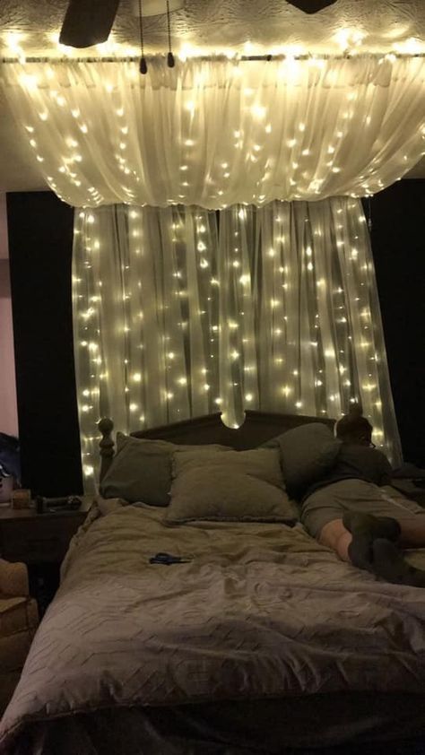 Canopy On Slanted Ceiling, Tulle Room Decor, Beds With Curtains Around It, Curtain Lights Above Bed, Wall Drapes Bedroom, Curtain Lights Behind Bed, Diy Canopy Bed With Lights, Curtain Lights Bedroom Ideas, Romantic Bedroom Lighting Ideas