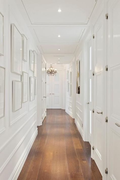 12 Decor Ideas to Make Narrow Hallways Look Bigger | Hunker Wall Trim Molding, Long Narrow Hallway, Narrow Hallways, White Hallway, Narrow Hallway Ideas, Narrow Hallway Decorating, Design Hallway, Upstairs Hallway, Entrance Modern