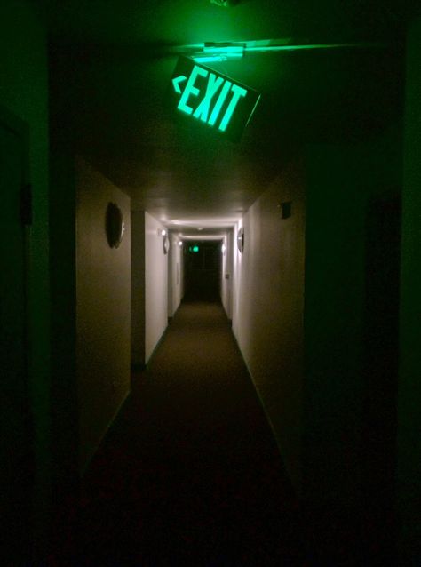 Green Exit Sign dangling in a eerie Hallway ~ Low Light Night Photography Over And Over, Infinite Hallway, Low Light Photography Ideas, Exit Wallpapers, Exit Door Aesthetic, Low Light Photography Outdoor, Scary Lighting, Hallway Photography, Green Liminal Space