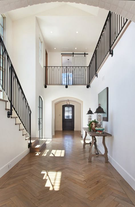 Transitional French Entry design with a touch of country French with the barn doors upstairs and the simple metal railing design. Transitional Interior Design, Balinese Decor, French Interior Design, Creative Shop, Entry Design, Staircase Railings, Wooden Floors, Railing Design, French Interior