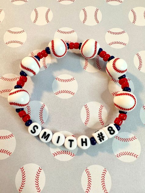 Customize the player or team name and number with this baseball beaded stretch bracelet. Perfect for players and fans!  Bracelets are available in a variety of lengths.  Pick your custom length from the drop down menu below.  Please be aware that beading may slightly differ from what is pictured as to accommodate selected sizing.  All our bracelets are made with quality in mind.  With that being said, all bracelets should be treated with care while putting on, wearing, and taking off.  Keep dry. Sports Mom Bracelet, Baseball Bracelet Diy, Baseball Mom Bracelet, Swiftie Bracelets, Baseball Ideas, Baseball Bracelet, Toms River Nj, Homemade Bracelets, Friendship Bracelets Designs