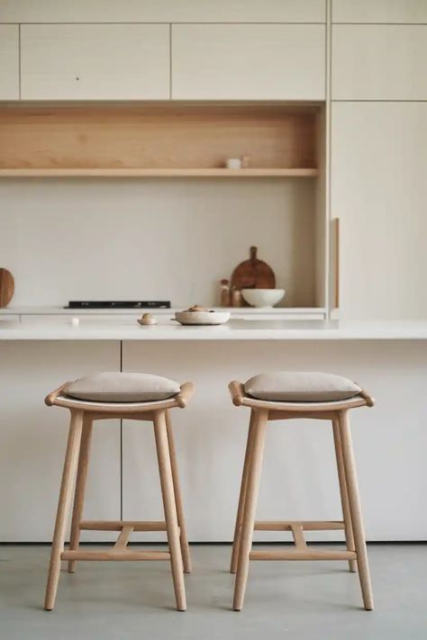 Two wooden bar stools with cushions in a minimalist kitchen. Minimalist Bar Stools, Kitchen Island Seating, Wood Combinations, Japandi Furniture, Island Seating, Japandi Kitchen, Rattan Bar Stools, Japandi Design, Minimalist Bar