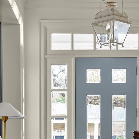 Kathy Kuo Home on Instagram: "The entrance to your home is like the start of a good book: There is so much wonder and possibility in the story that is about to unfold. The first few pages—aka your foyer—is just the beginning! 

📷 @nathanschroderphoto @jbheditorial

Built by @renaudinbuilders" Blue Interior Front Door, Front Door With One Sidelight, Houston Design, Beautiful Entryways, Southern Design, Entry Design, Light Layers, Small Lanterns, Timeless Interiors