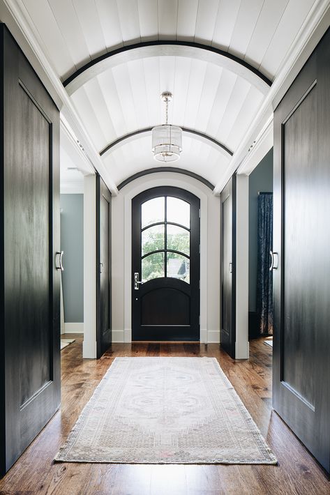 Gorgeous entryway with concealed barn doors underneath a white barrel vault paneled ceiling. | Amy Storm & Company | #entryway #archedceiling #entrywayideas #runner #barndoors Long Foyer, Barrel Vault Ceiling, Barrel Ceiling, Wood Parquet Flooring, Stone Backsplash, Long Hallway, Entrance Foyer, Foyer Design, Entry Way