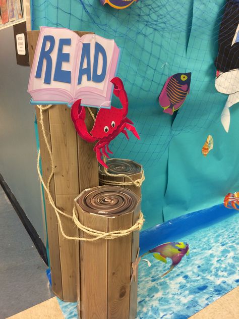 Scholastic Under the Sea Book Fair Decorations Underwater Reading Corner, Fair Decorations, Pirate Decorations, Pirate Ideas, Cardboard Boat, Nautical Books, Ocean Books, Book Fairs, Under The Sea Decorations