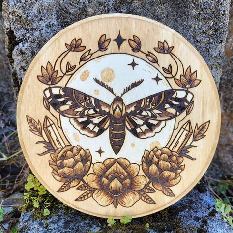 This hand wood burned moth and moon wall hanging is looking for the perfect home! Link to my shop in bio. 🔥🌙 https://moonmothandtorch.etsy.com #moonmothandtorch #melissacalvert #moth #moon #crystals #garden #pyrography #pyrographersofig #pyrographer #woodburning #woodburned #cottage #cottagecore #cottagewitch #hedgewitch #nature #woodart #flowers #witch Cottagecore Witch, Moon Wall Hanging, Cottage Witch, Hedge Witch, Wood Burning Art, Pyrography, Wood Burning, Wood Art, Hanging Signs