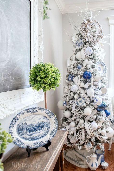 Nov 6, 2018 - My blue and white Christmas tree has a French farmhouse feel. I've hung vintage dishes and teacups from my tree, along with plenty of handmade ornaments! Come take a closer look at www.diybeautify.com! #blueandwhite #christmastree #farmhouse Pale Blue Christmas Decor, Country French Christmas Decorating, Blue Willow Christmas Tree, White French Farmhouse, French Country Christmas Tree, French Farmhouse Christmas, Christmas Decor Blue, Blue White Christmas, Blue And White Christmas