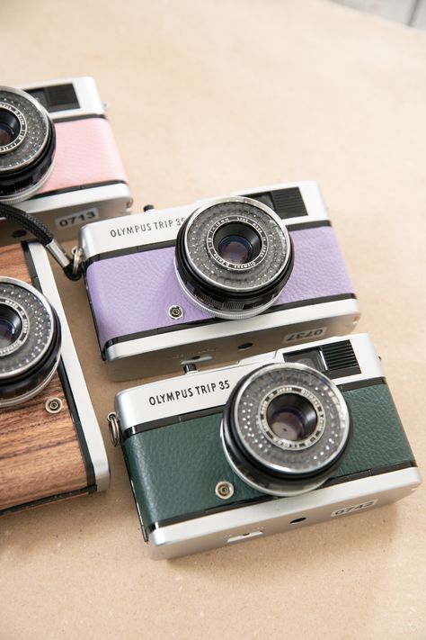 Olympus Trip 35 35mm film cameras in dark green and lilac on a kraft paper background Olympus Camera Aesthetic, Olympus Trip 35, Film Leader, Aperture Settings, Olympus Camera, Kodak Gold, Rangefinder Camera, 35mm Camera, Camera Shop