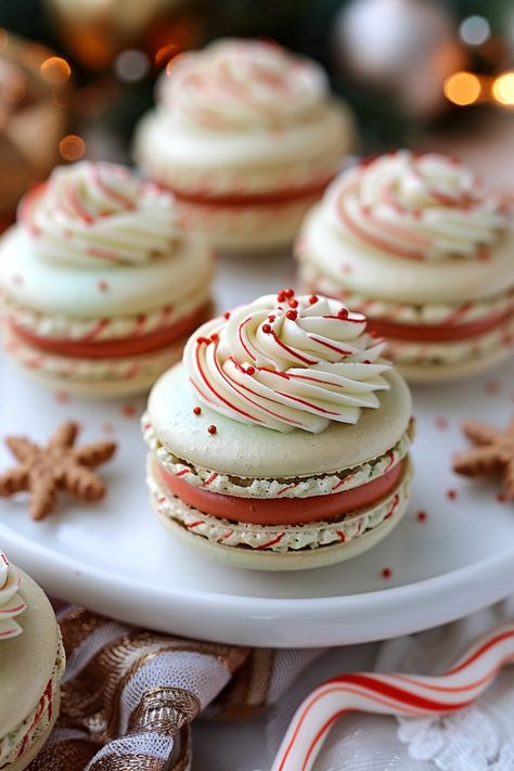 Festive macarons with red and white swirls and sprinkles on a plate, surrounded by holiday decorations. Macaron Place Setting, Fall Flavored French Macarons, Peppermint Macarons Recipe, Christmas French Macarons, Christmas Maccarone, Christmas Flavored Macarons, Macaron Template Free Printable, Classic Christmas Baking, Fall Flavored Macarons