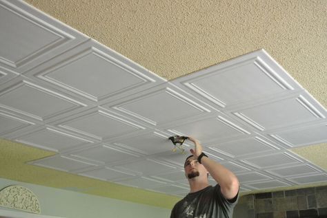 What an easy and relatively inexpensive way to cover up the 80's popcorn ceiling . No mess no scraping. Just glue up ( we used cheap caulk for the adhesive) These ultra lite tiles made of recycled Styrofoam are easy to cut and can be painted.It would have cost around $1200 to have the old ceiling scraped down and another $1200 to have it refinished and painted . I spent around $600 total. I think it looks fantastic and with out all the mess ! Only 2 more cut pieces to go. Place the… Cheap Ceiling Ideas, Styrofoam Ceiling Tiles, Covering Popcorn Ceiling, Easy Home Improvement Projects, Beadboard Ceiling, Ceiling Texture, Popcorn Ceiling, Garage Remodel, Diy Ceiling