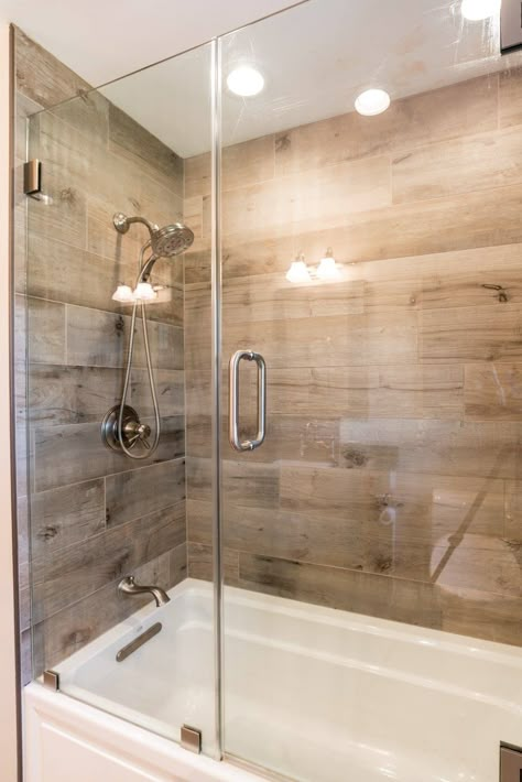 Wood Tile Shower Ideas With Tub, Wood Look Tile In Shower Walk In, Wood Tile Tub Surround, Wood Accents In Bathroom, Wood Tile Bathroom Ideas, Wood Tile Bathtub, Wood Grain Tile Bathroom, Bathroom Shower Tile Ideas 2024, Shower Wood Tile