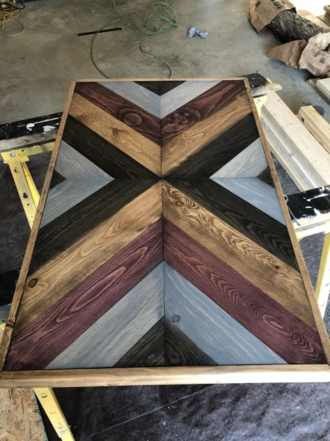 Multi-stained x-shaped table Chevron pattern Multi Color Stained Wood Table, Chevron Pattern Table Top, Aztec Table Top, How To Make A Chevron Pattern With Wood, Table Top Patterns, Chevron Pattern Wood, Diy Dining Room Table, Chevron Table, Painted Coffee Tables