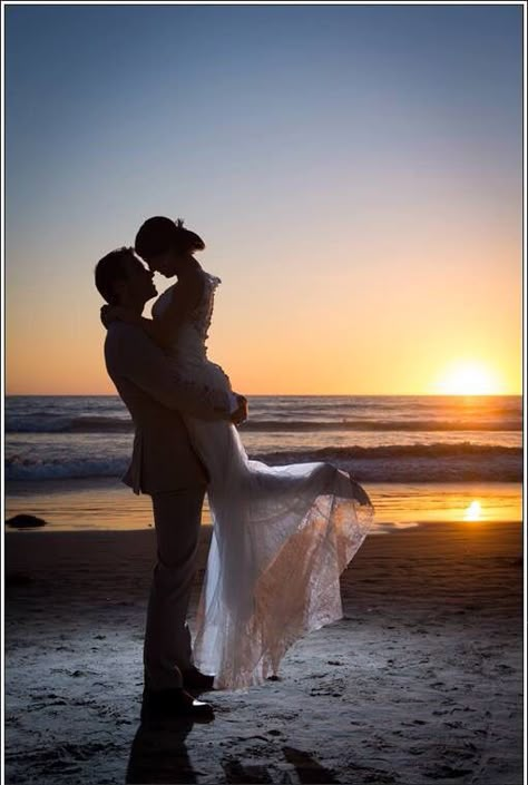 Love my wedding photo with the sunset in the background on the beach. Just be careful of your groom is wearing expensive shoes! Ocean water and leather isn't a good mix. Groom Beach Shoes, Wedding Photos In The Ocean, Unique Beach Wedding Photos, Beach Wedding Picture Ideas Photography, Sunrise Beach Wedding Ceremony, Beach Wedding Photography Ideas, Ocean Wedding Pictures, Beach Wedding Photo Inspiration, Wedding By The Ocean