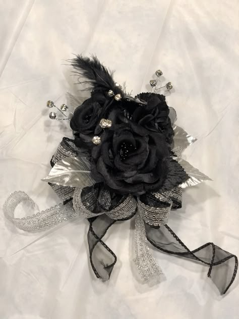 Black and silver corsage Black Prom Bouquet Ideas, Corsage Prom Black And Silver, Emo Corsage, Goth Prom Corsage, All Black Corsage, Black And Silver Boutonniere, Black And Silver Corsage And Boutonniere, Corsage Black Dress, Corsage Prom Black