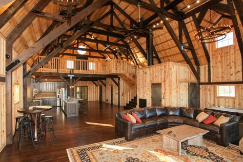 WOW! Gorgeous barn home with an open floor plan! The dark beams really stand out!  Sand Creek Post & Beam Gambrel Barn, Barndominium Interior, Stone Fireplaces, Carriage Doors, Barn Living, Wood Walls, Farmhouse Barndominium, Barn Design, House Features