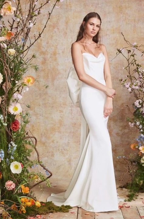 Draped strapless stretch satin siren gown with exaggerated detachable winged bow.

Theia Bridal | Style: MAGENTA Theia Bridal, Theia Couture, Modern Bridal Gowns, Kleinfeld Bridal, Bridal Gowns Mermaid, Fit And Flare Wedding Dress, Fitted Wedding Dress, Wedding Dresses Strapless, Perfect Wedding Dress