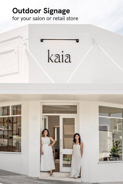 Exterior view of 'Kaia' salon showcasing a minimalist white sign with black lettering mounted on a clean, white facade. Two smiling women stand at the entrance, inviting a warm welcome to clients Japanese Beauty Salon, Beauty Academy Design, Dream Hair Salon, Hair Salon Signage, Spa Signage, Hair Spa Salon, Aesthetic Salon, Neon Studio, Spa Interior Design