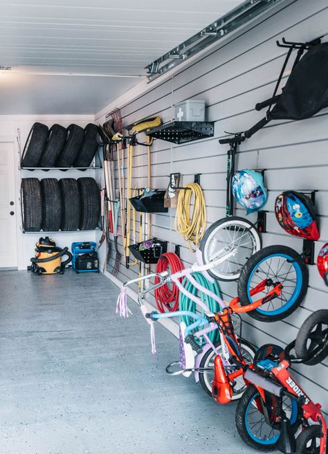 Great garage storage ideas- love the tire storage and the hooks for the kids bikes and helmets! Kids Bike Storage, Garage Organization Shelves, Garage Wall Shelving, Tire Storage, Garage Organisation, Garage Floor Paint, Bike Wall, Overhead Garage, Small Garage