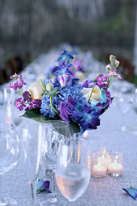 Blue and Purple Flower Centerpieces Blue Purple White Flower Arrangement, Blue Purple Party Decor, Blue Violet Wedding Theme, Purple Blue White Wedding Centerpieces, Purple Blue Gold Party Decorations, Purple Blue Centerpiece, Blue And Purple Reception Decor, Blue Purple And Ivory Wedding, Navy And Purple Flowers