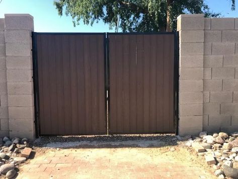 I love that this RV has a black trim that frames the wooden doors. My wife and I recently bought an RV, and we need to ensure that it isn't vandalized while we are on a business trip since we have it parked in our backyard. We'll consider getting a stylish RV gate like this. Rv Gate, Custom Metal Fabrication, Buying An Rv, Entry Gates, Metal Trim, Metal Fabrication, My Photo Gallery, Builder Website, Business Travel