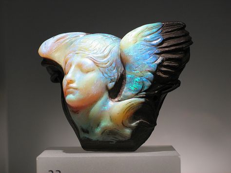 "Dream Cloud"  This piece is a Queensland, Australia boulder opal carving of a "winged female bust as personification of the dream" with the face turned well right, eyes closed. The entire carving weight is 1167 carats. Presently in the collection of the Royal Ontario Museum Bijoux Art Nouveau, Royal Ontario Museum, Crystal Power, Blue Angel, Art Nouveau Jewelry, Art Antique, Rocks And Gems, Minerals And Gemstones, Gems And Minerals