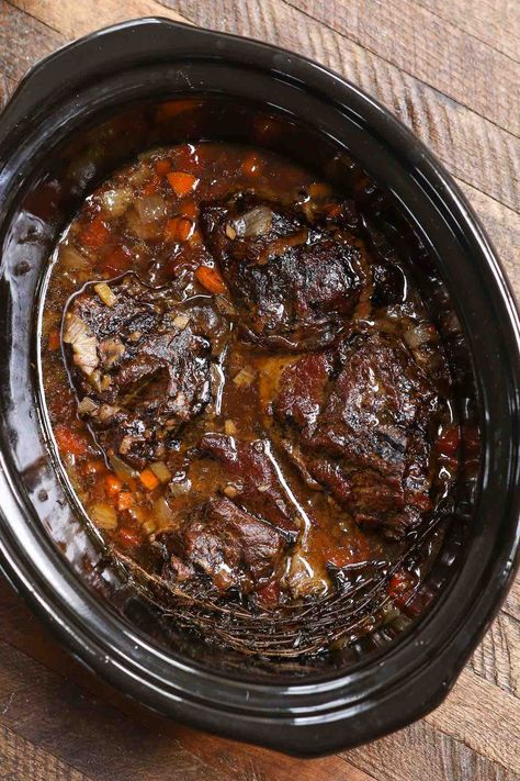 Slow cooked beef with vegetables in a crock pot Slow Cooker Beef Cheeks In Red Wine, Crock Pot Braised Beef, Braised Beef In Crock Pot, Red Wine Braised Beef Crock Pot, Braised Beef Cheeks, Beef Cheeks Recipe Slow Cooker, Beef Cheek Meat Recipe, Beef Cheeks Slow Cooker, Beef Cheeks Recipe