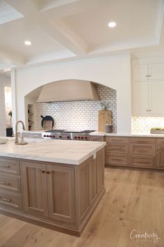 All Oak Kitchen, Grand Traditions Homes, Stone Fireplace Family Room, White Cabinets With Taupe Island, Master Bed Closet Ideas, Track Home Kitchen Remodel, Herschel Hickory Pergo, Flat Island Kitchen, Light Wood Stain Kitchen Island