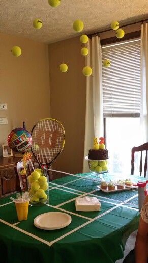 My son's tennis party for his 12th birthday! For the floating tennis balls hanging from my ceiling; I used 2 clear rubber bands crossed on a tennis ball and tied fishing line through them. Then I tied it to a push pin and stuck it in the ceiling! Tennis Party Ideas, Tennis Themed Party, Tennis Decorations, Grad Table, Tennis Decor, Tennis Crafts, Tennis Birthday Party, Wimbledon Party, Tennis Birthday