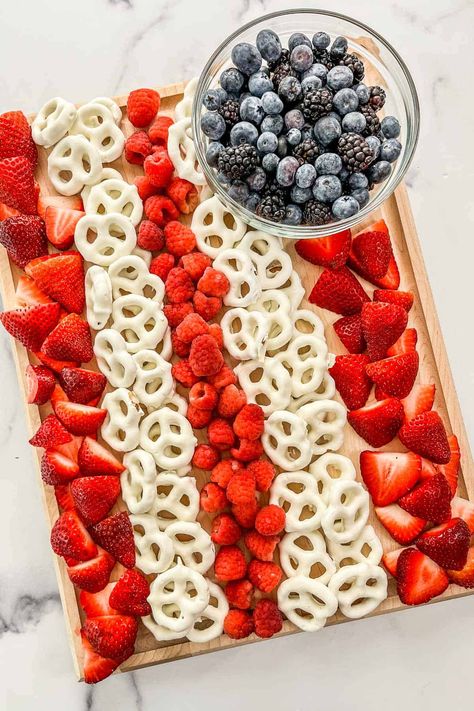 This easy American flag fruit tray is the perfect snack for patriotic parties! Made with fresh fruit and tasty pretzels, it's a simple treat that makes an easy dessert or appetizer. Fruit American Flag, American Flag Fruit Tray, Flag Fruit Tray, Fourth Of July Veggie Tray, 4th Of July Fruit Platter, Patriotic Fruit Tray, American Flag Desserts, Fourth Of July Fruit Tray, American Flag Charcuterie Board