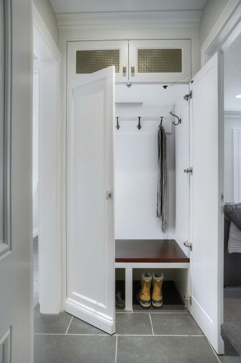 Hidden Mudroom! Concealed mudroom hidden behind double doors featuring oil-rubbed bronze coat hooks over built-in bench with shoe storage underneath. Boot Room Utility, Small Mudroom, Transitional Laundry Room, Utility Room Designs, Front Foyer, Mudroom Closet, Mudroom Makeover, Mudroom Laundry, Coat Storage