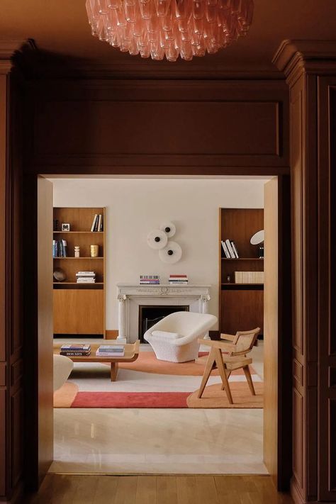 This modern home features a dark brown-painted foyer is teamed with a light pink chandelier that almost takes on qualities of a neutral in this color-drenched room. In the living room beyond, a rug with soft oranges and reds proves these shades also work brilliantly with the dark brown color in this vestibule. In isolation, this palette might feel surprisingly colorful, but united by the dark brown, it feels grown-up and co-ordinated. Shot by @lucamadani Designed by @hauvette_madani Brown Color Scheme, Monochromatic Color Scheme, Architecture Awards, Lake Geneva, Sustainable Design, Interior Design Trends, Geneva, Modern House Design, Interior Inspiration