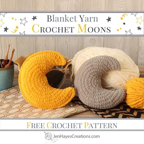 One yellow and one grey crochet moon pillows sitting on some fabric pieces with yarn skeins, a bowl, and a cup full of crochet hooks in the background. Text overlay, "Blanket Yarn, Crochet Moon, Free Crochet Pattern, JenHayesCreations.com." Crochet Plush Pillow, Blanket Yarn Crochet, Crochet Moon, Moon Crochet, Confection Au Crochet, Crochet Pillow Pattern, Crochet Design Pattern, Beginner Crochet Projects, Crochet Home Decor