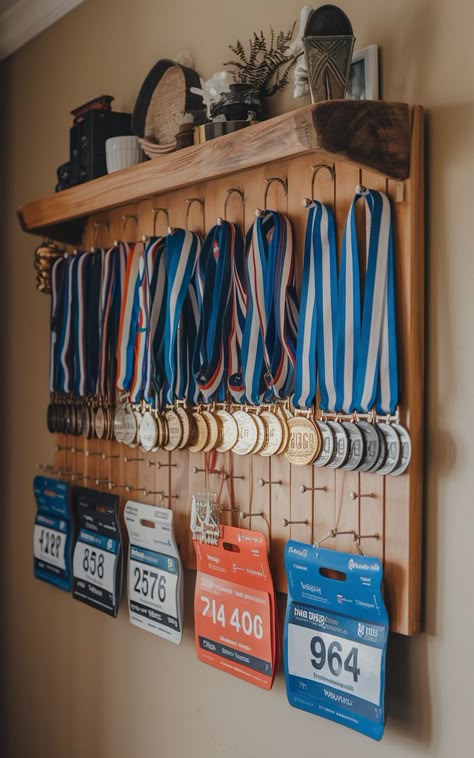 A homemade race bib holder and medal rack displaying an array of race bibs and medals. Hanging Medals Ideas, Running Medal Display Ideas, Medal Display Ideas, Race Bib Display, Hanging Medals, Race Bib Holder, Race Medal Displays, Marathon Medal Display, Running Medal Display