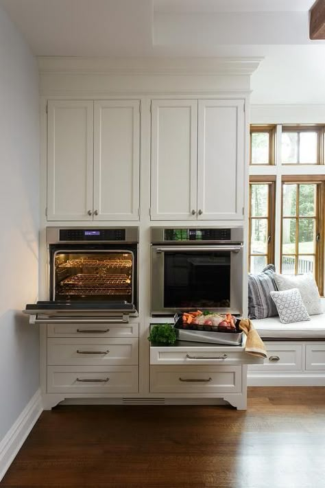 Side by side wall oven are mounted beneath white shaker cabinets and above drawers fitted with a stainless steel pull out tray countertop. White Shaker Cabinets, Custom Cabinet, Shaker Cabinets, Cabinet Ideas, Kitchen Farmhouse, Transitional Kitchen, Kitchen Plans, Kitchen Redo, Kitchen Remodeling