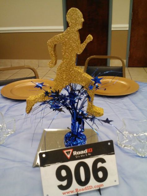 Centerpieces for Track & Field banquet. Used runners bib for table numbers. #sports, #centerpieces, # runners, # track & field ,#marathon, # cross country, # table numbers Track And Field Themed Party, Running Centerpieces, Track Centerpiece Ideas, Track And Field Party Decorations, Marathon Party Theme, Cross Country Centerpiece Ideas, Cross Country Banquet Centerpieces, Track Banquet Centerpieces, Cross Country Decorations