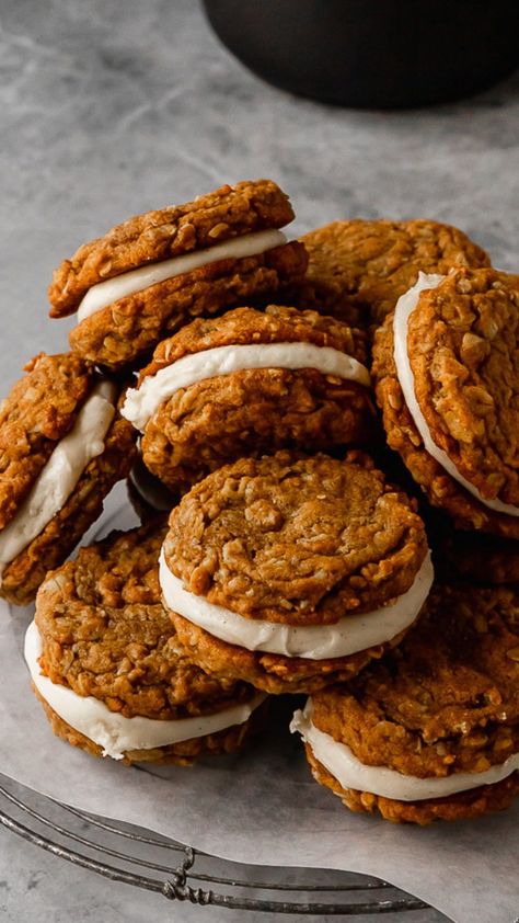 these pumpkin oatmeal cream pies are a fun fall remake of the classic childhood treat. they’re made from spiced chewy pumpkin oatmeal cookies sandwiched together with a maple cream cheese buttercream. Oatmeal Pumpkin Whoopie Pies, Homemade Fall Baked Goods, September Deserts, Pumpkin Spice Oatmeal Cream Pies, Recipes With Pumpkin Pie Spice, Seasonal Cookies Fall, Pumpkin Moon Pies, Thanksgiving Recipes Untraditional, Rustic Fall Recipes