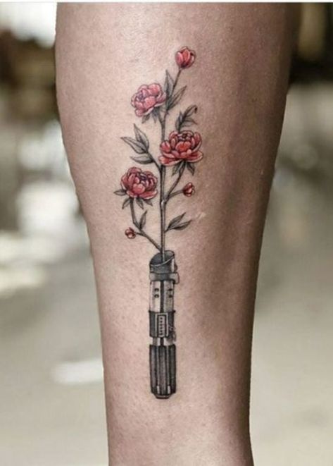 25 Star Wars Tattoo Ideas That You Will Absolutely Adore Starwars Tattoo Girly, Flower Lightsaber Tattoo, Star Wars Tattoo Flowers, Starwars Flower Tattoo, Lightsaber With Flowers Tattoo, Nerd Tattoos For Women, Star Wars Tattoo Aesthetic, Star Wars Flower Tattoo, Lightsaber Flower Tattoo