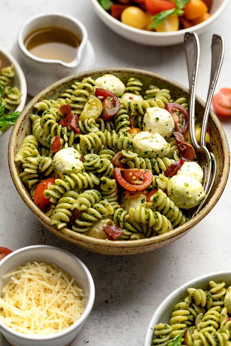 The best Summer flavors in a pasta salad! All the flavors of a classic caprese salad with a twist. Use a kale & basil pesto, crispy prosciutto, and pasta with fresh cherry tomatoes and mozzarella. Use mozzarella pearls (so cute and easy!) or dice fresh mozzarella into cubes. Use penne or your favorite shaped pasta - all work great. Leave out the prosciutto for a vegetarian dish. Fast and easy to make and a perfect side dish for a summer meal! Pasta Salad With Pesto, Spicy Taco Seasoning, Garlic Scape Pesto, Tomatoes And Mozzarella, Shaped Pasta, Crispy Prosciutto, Mozzarella Pearls, Summer Flavors, Caprese Pasta Salad