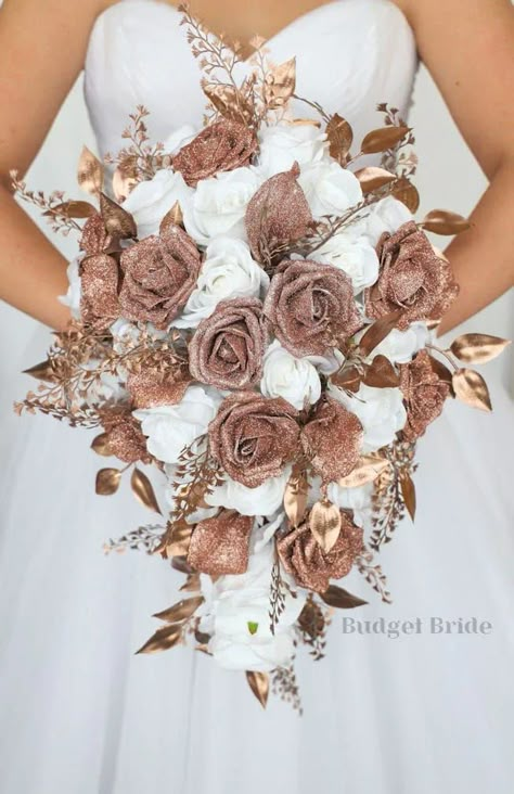 This is a cascading brides bouquet with white roses accented by rose gold glitter calla lilies, roses, and rose gold foliage. All of our wedding bouquets are made with artificial wedding flowers. Rose Gold Wedding Bridesmaids Dresses, Wedding Dresses With Rose Gold, White And Rose Gold Wedding Dress, Rose Gold Wedding Ideas Decor, Rose Gold And Brown Wedding Theme, Brown And Rose Gold Wedding, Rose And Brown Wedding, Rose Gold Wedding Nails For Bride, Rose Gold Wedding Color Schemes