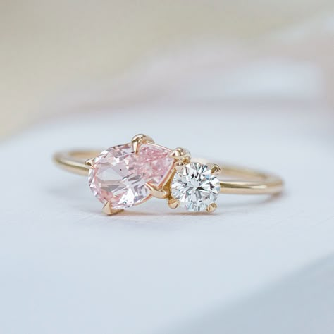 Asymmetry at its finest. This double solitaire features a 1.16ct pear cut peach Sapphire paired with a round brilliant cut diamond. Simple beauty, handcrafted in 14k yellow gold. This ring was created for the Life in Colour collection. It is one of a kind, from our curated collection of sapphires. Ring Details Pear Cut Natural Peach Ceylon Sapphire This sapphire is Natural Corundum (No Indication of heating) 4mm brilliant cut Round laboratory created diamond Ring size 7* 14k yellow gold Availabl Simple Pear Ring, Pear And Round Diamond Ring, Pink And Gold Engagement Ring, Pink Saphire Engament Ring, Peach Diamond, Peach Sapphire Rings, Peach Sapphire Engagement Ring, Pink Diamond Ring, Colour Collection