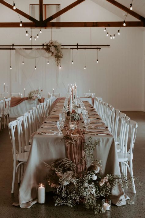 Soft billowing draping paired with linen tablecloths, loosely woven runners, tulle and sleek tableware brought a subtle texture contrast to the setting. "A lot of our couples are opting for an alternate drop menu so we really wanted to showcase a table setting that was not only beautiful but also functional for style of menu. The two stunning NeWhite silhouettes fit into the setting seamlessly complementing the beautiful architecture in the barn along with the soft textural elements. The florals were kept simple, we paired delicate florals such as orchids and roses with whimsical and coarser foliage." Ash shares. Dusty Rose Gold Wedding, Brown Wedding Themes, Rose Gold Wedding Theme, Farm Wedding Ideas, Gold Wedding Inspiration, Gold Wedding Theme, Dusty Rose Wedding, Brown Wedding, Neutral Wedding