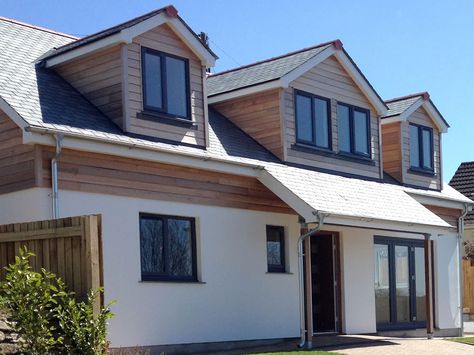 This development was of a 4 Bed-roomed dormer bungalow located in the centre of Helston. It was designed to provide a more contemporary look to make it stand out from the neighbouring properties. We used Western red cedar cladding and natural slate to enhance the quality look of the property. Cedar Dormers, Rendered Dormer Bungalow, Dormer Extension, Exterior Wood Cladding, Western Red Cedar Cladding, Bungalow Conversion, Contemporary Bungalow, Dormer Bungalow, Bungalow Extensions