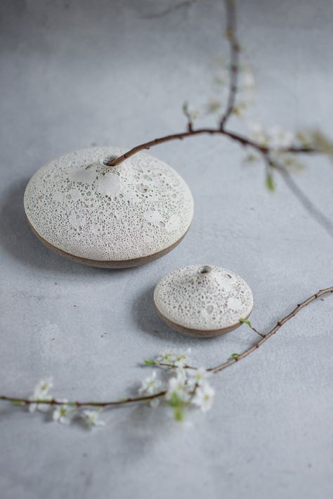 A contemporary minimal bud vase ideal for single stems, handmade by Laima from her studio in rural Latvia. The elegant shape in combination with the raw, textured surface create a unique design object. Treasure the beauty of imperfection an embody the aesthetic principles of wabi-sabi. Artfully handcrafted on the pottery wheel from high-fired stoneware. Glazed with crater lava glaze- surface may be decorative and rough to touch. Functional vase (holds water). Each one is unique. Shapes vary slig Mini Ceramic Vase, Wabi Sabi Jewelry, Japanese Pottery Wabi Sabi, Cermaic Bud Vase, Wabi Sabi Vase Pottery, Nordic Naturals, Handmade Ceramics Vase Japanese, Wabi Sabi Aesthetic, Organic Ceramics