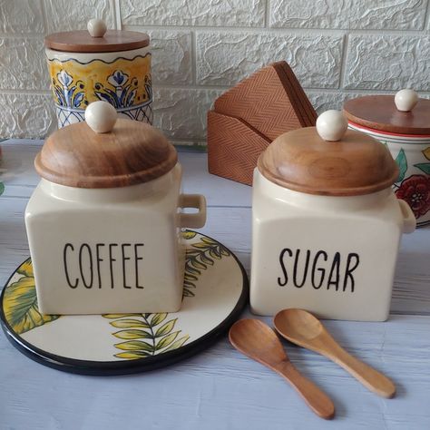 Organize in style with our chic ceramic storage jars, each adorned with a wooden airtight lid. Perfect for your kitchen essentials! 🏺✨ Set of 2 Sugar & Coffee Canisters Shop now WhatsApp +91-9779926125 for more details and order or email us at contactus@pankhhari.com . . . #homedecor #kitchenessentials #kitchencontainers #ceramicjar #coffeejar #sugarjar #coffeesugar #pankhhari Coffee Canisters, Ceramic Storage, Coffee Storage, Coffee Jars, Sugar Jar, Kitchen Containers, Ceramic Jars, Storage Jars, Kitchen Essentials