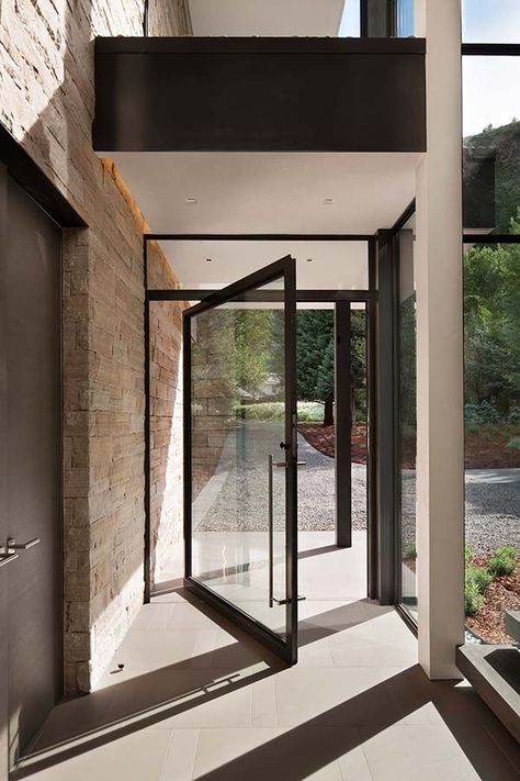 Stone and glass home in Aspen surrounded by trees Modern Front Entry, Steel Pivot Door, Door Architecture, Street Dreams, Exterior Entry Doors, Flat Door, Prairie House, Pivot Door, Door Entrance