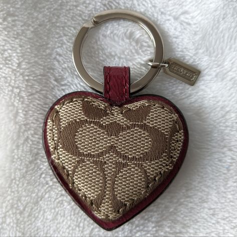 Nwot Coach Signature Heart Keyring / Bag Charm. Features Signature Canvas Trimmed In Burgundy Leather. Approximate Measurements Not Including Keyring 1 3/4"(W) X 1 1/2"(H). Beautiful Keyring! Coach Bag Charms, Purse Decor, Mini Duffle Bag, Purse Collection, Holiday Wishlist, Leather Lanyard, Pretty Aesthetic, Shoe Nails, Gift Inspo